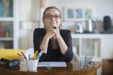 Portrait of mature woman sitting at desk - CUF22800