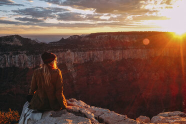 Woman sitting on edge of Grand Canyon, Arizona, USA - ISF08781