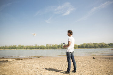 Man flying drone at a river - ONF01139