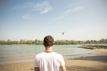 Man flying drone at a river - ONF01140