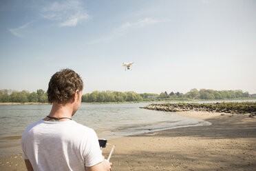 Man flying drone at a river - ONF01145