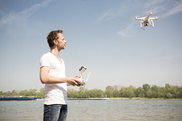 Man flying drone at a river - ONF01146