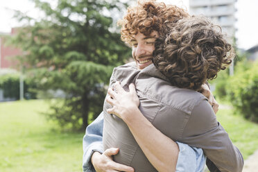 Friends hugging in park - CUF22829