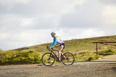 Cyclist riding on gravel road - CUF22859