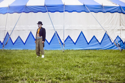 Portrait of senior male circus clown outside circus tent - CUF22980