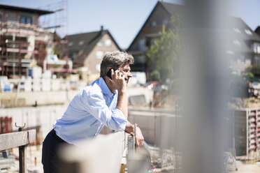 Man on cell phone on construction site - MOEF01303