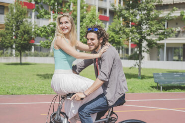 Couple on bicycle in park - CUF22998