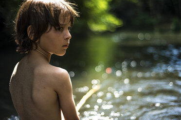 Rear view of boy by water looking away over shoulder - CUF23036