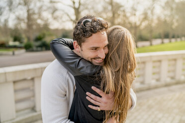 Romantic young couple hugging in Battersea Park, London, UK - CUF23082