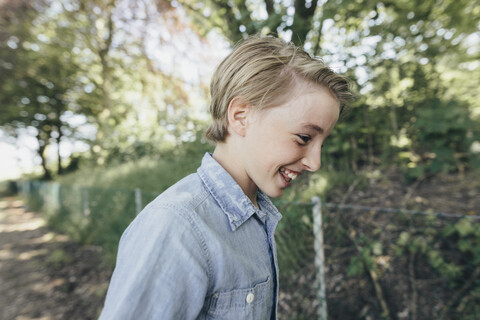 Laughing boy on forest path stock photo