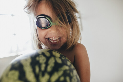 Happy girl with a watermelon wearing swimming goggles stock photo