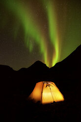 Illuminated tent and Aurora borealis at night, Khibiny mountains, Kola Peninsula, Russia - CUF23111