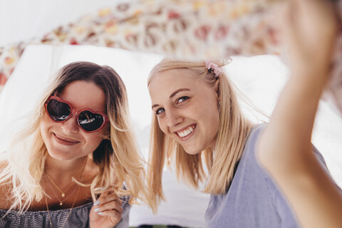 Portrait of two happy young women in a teepee stock photo