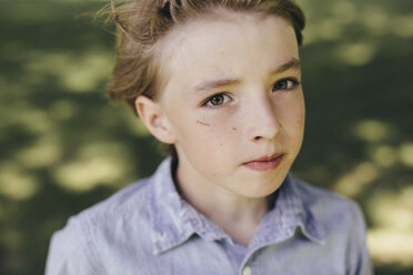 Portrait of serious boy outdoors - KMKF00358