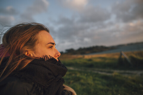 France, Brittany, Landeda, woman in rural landscape at dusk stock photo