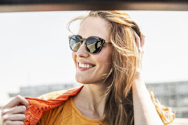 Portrait of smiling woman wearing sunglasses - FMKF05110