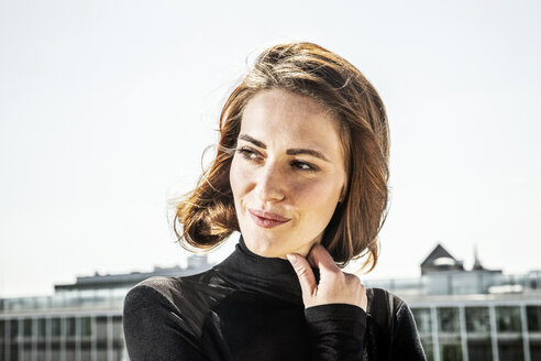 Portrait of smiling woman with blowing hair - FMKF05121