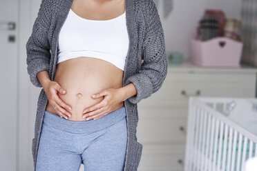 Pregnant woman stroking baby belly - ABIF00521