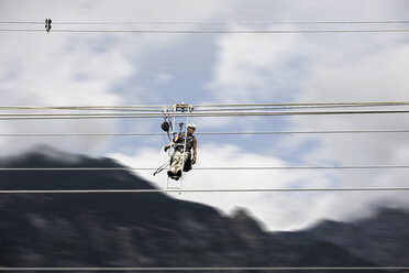 Fitter with ladder, rolling along high-voltage power line - CVF00697