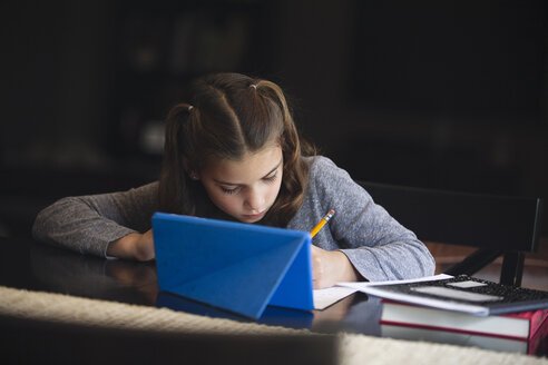 Girl at desk writing - ISF09039