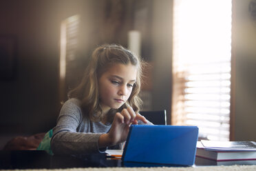 Girl at desk using digital tablet - ISF09041