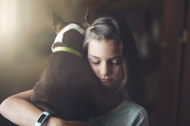 Girl hugging boston terrier dog - ISF09059