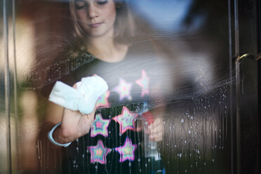 Girl cleaning glass door - ISF09149