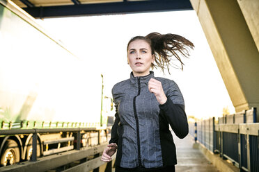 Portrait of sportive woman jogging - MMIF00129