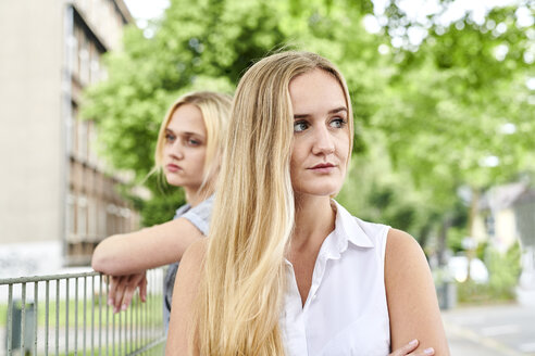 Two discontented young women outdoors - MMIF00146