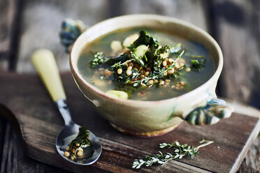 Bowl of broth on wooden cutting board - CUF23130