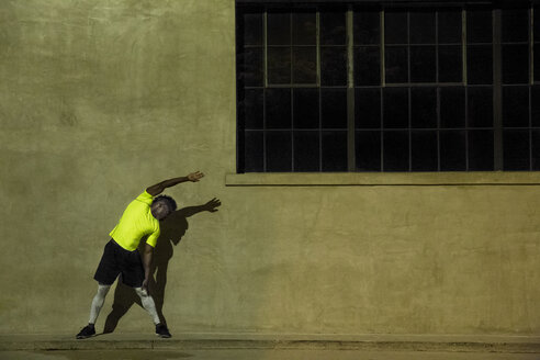 Young man exercising at night, in urban setting - ISF09224