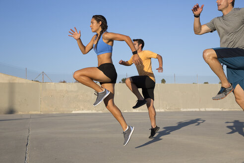 Athletes doing high knees exercise, Van Nuys, California, USA - ISF09288