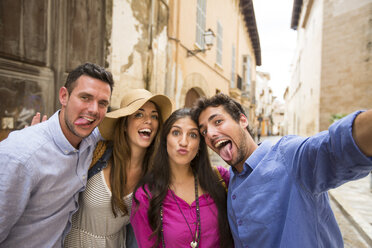 Couples making faces and taking selfie on street, Palma de Mallorca, Spain - CUF23223