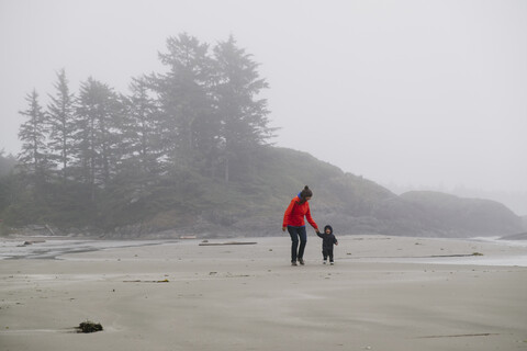 Mutter und Sohn gehen am Strand spazieren, Long Beach, Vancouver Island, British Columbia, Kanada, lizenzfreies Stockfoto
