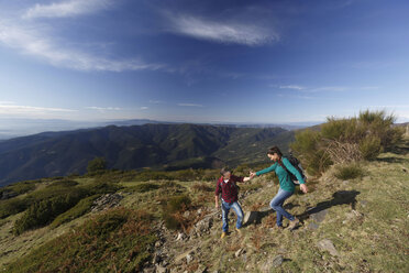 Hikers trekking on hilltop, Montseny, Barcelona, Catalonia, Spain - CUF23291