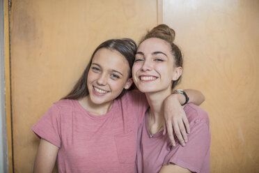 Portrait of two smiling teenage girls hugging - ZEF15634