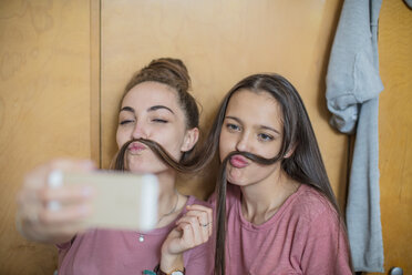 Playful happy teenage girls taking a selfie - ZEF15638