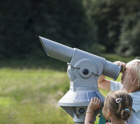 Brother and sister looking through binoculars - CUF23344