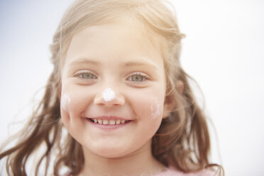 Little girl with sun cream on nose - CUF23418