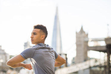 Man stretching, Wapping, London, UK - CUF23517