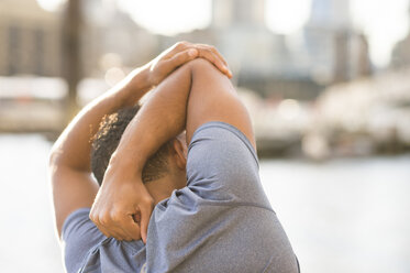 Man stretching, Wapping, London, UK - CUF23518