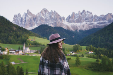 Woman looking over shoulder, Santa Maddalena, Dolomite Alps, Val di Funes (Funes Valley), South Tyrol, Italy - CUF23564