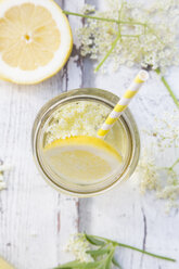 Glass of homemade elderflower sirup with slices of lemon - LVF07041