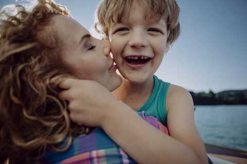 Mother and happy son at a lake stock photo