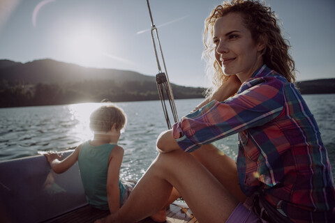 Smiling mother with son on a sailing boat stock photo