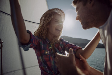 Happy couple on a sailing boat - JLOF00074