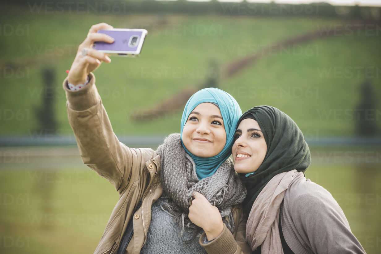 Premium Photo | Pretty best friends taking selfie with camera.