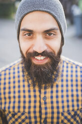 Portrait of mid adult man wearing beanie hat, outdoors - CUF23729