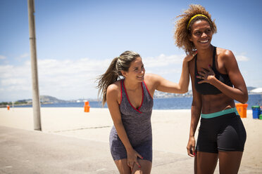 Young women laughing on beach - CUF23792