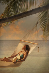 Mid adult woman relaxing in hammock, Ari Atoll, Maldives - CUF23873